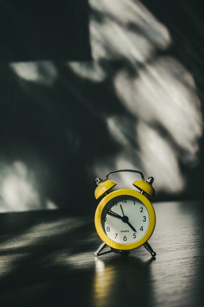 white and gold analog alarm clock